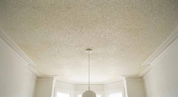 Dated popcorn ceiling before removal